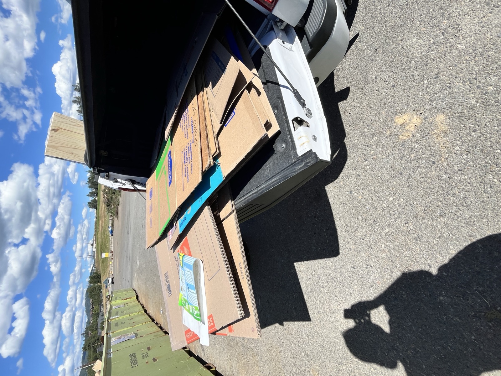 Pickup truck bed loaded with broken-down cardboard boxes headed to the recycling dump